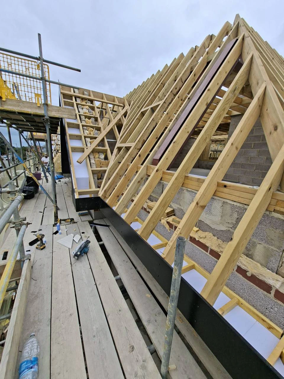 Newly built timber roof structure with pitched rafters